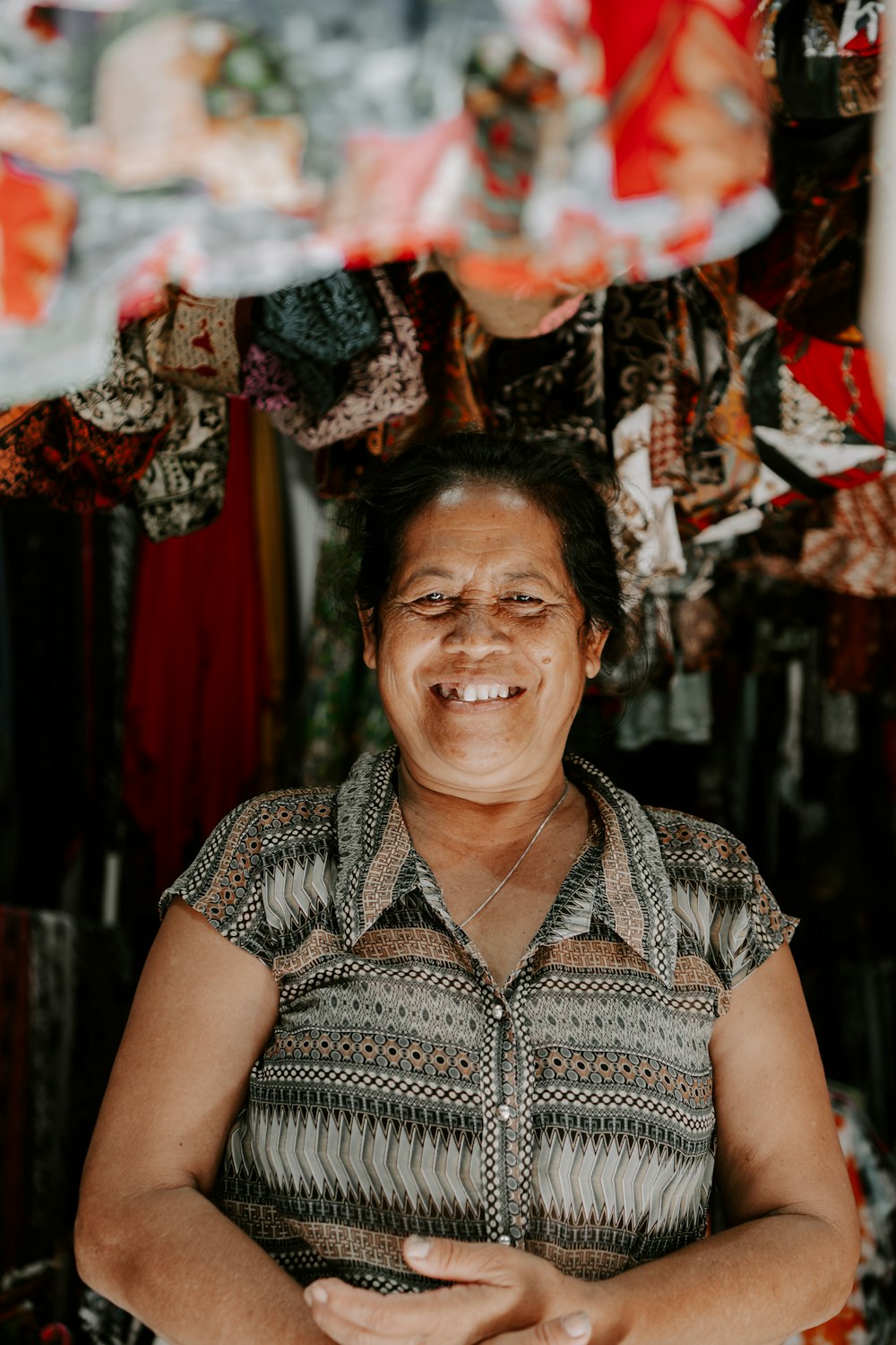 A smiling shop owner among her racks